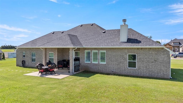 29731 Jade St, Cashion, OK 73016 - back of house featuring a patio, a yard, a shingled roof, and brick siding