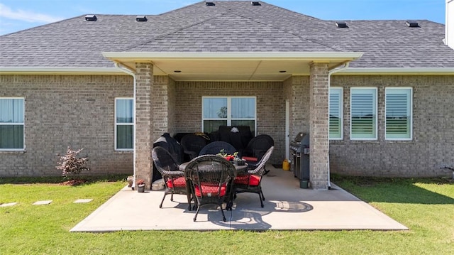 29731 Jade St, Cashion, OK 73016 - rear view of house with a shingled roof, a patio, a yard, and brick siding