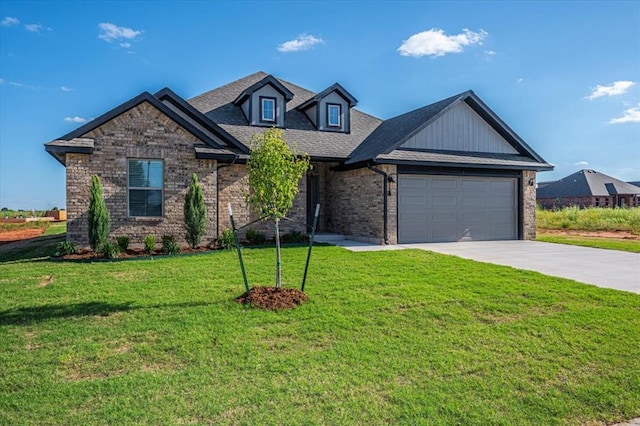 2000 W Flintlock Way, Mustang, OK 73065 - view of front of property with driveway, an attached garage, a front lawn, brick siding, and a shingled roof