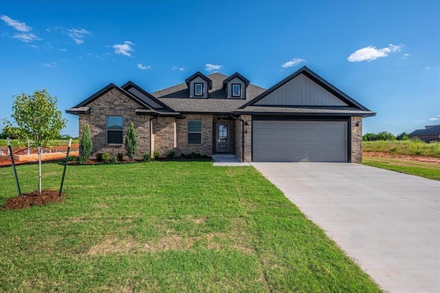 2000 W Flintlock Way, Mustang, OK 73065 - view of front of home with a garage, brick siding, a front lawn, and driveway