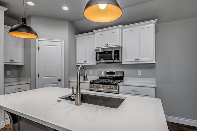 2000 W Flintlock Way, Mustang, OK 73065 - kitchen featuring stainless steel appliances, baseboards, a sink, light countertops, and recessed lighting