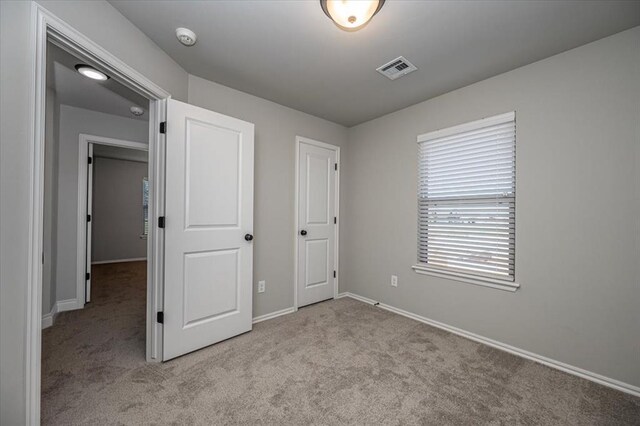2000 W Flintlock Way, Mustang, OK 73065 - unfurnished bedroom featuring carpet floors and baseboards
