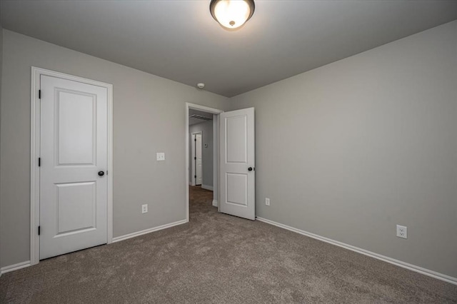 2000 W Flintlock Way, Mustang, OK 73065 - unfurnished bedroom featuring carpet and baseboards