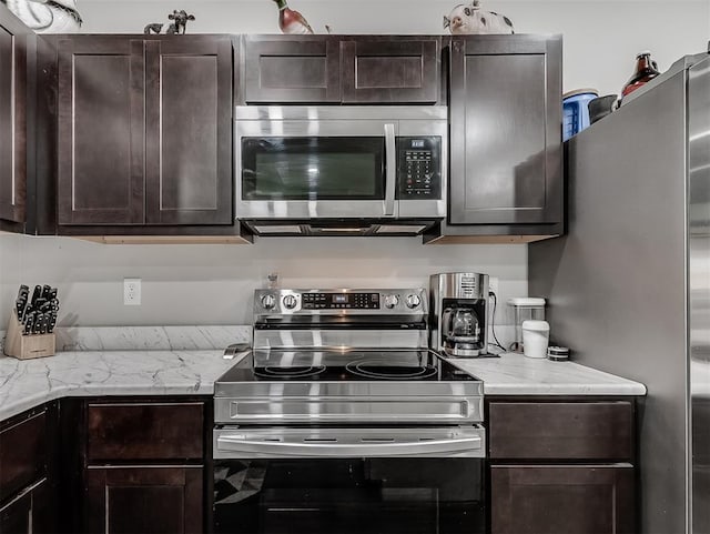 42173 N Max Henry Dr, Shawnee, OK 74804 - kitchen with stainless steel appliances, dark brown cabinetry, and light stone countertops