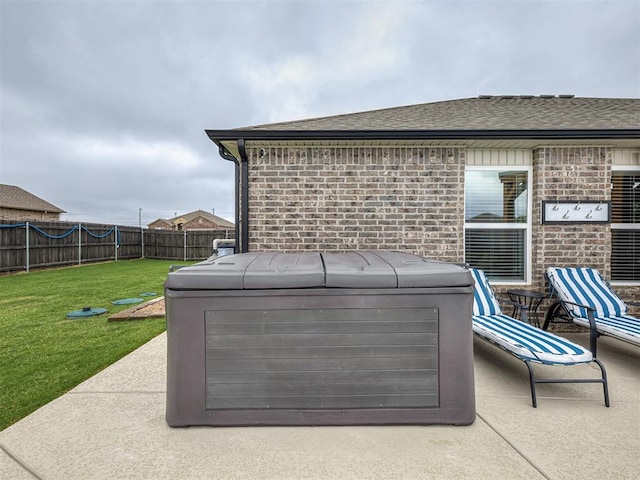 42173 N Max Henry Dr, Shawnee, OK 74804 - exterior view of a hot tub, a fenced backyard, a downspout, brick siding, and roof with shingles