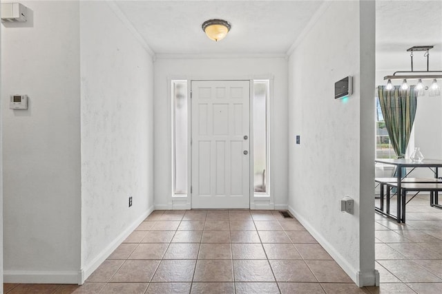 2020 Lyle Rd, Weatherford, OK 73096 - tiled entrance foyer with ornamental molding, a textured wall, and baseboards
