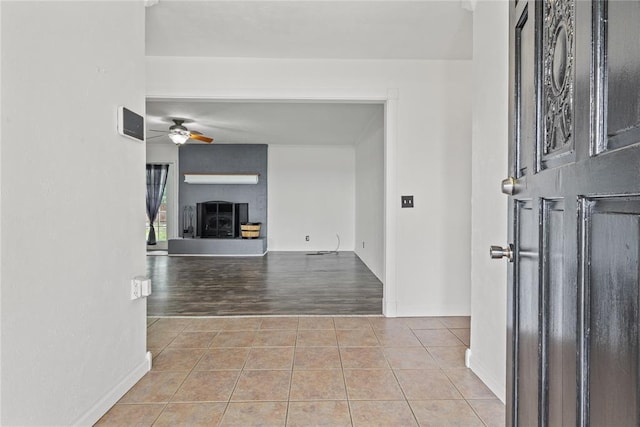 2020 Lyle Rd, Weatherford, OK 73096 - foyer entrance featuring a ceiling fan, tile patterned flooring, a large fireplace, and baseboards