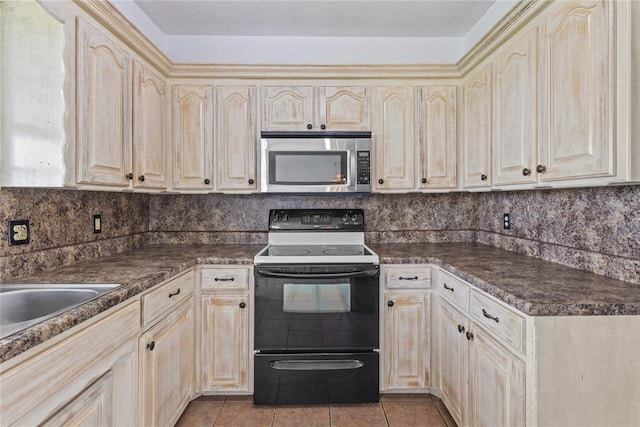 2020 Lyle Rd, Weatherford, OK 73096 - kitchen featuring stainless steel microwave, range with electric cooktop, dark countertops, and decorative backsplash