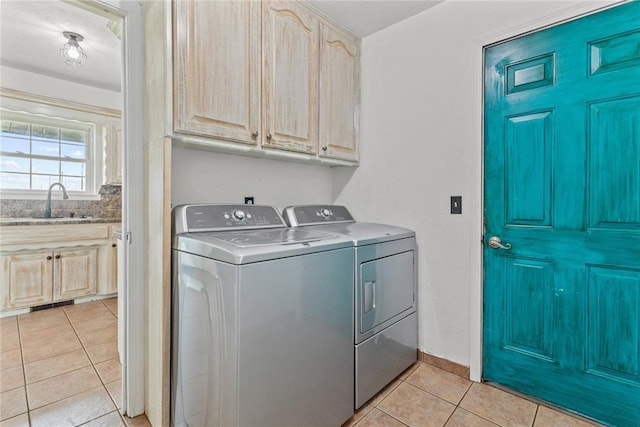2020 Lyle Rd, Weatherford, OK 73096 - laundry room with washer and dryer, light tile patterned flooring, cabinet space, and baseboards
