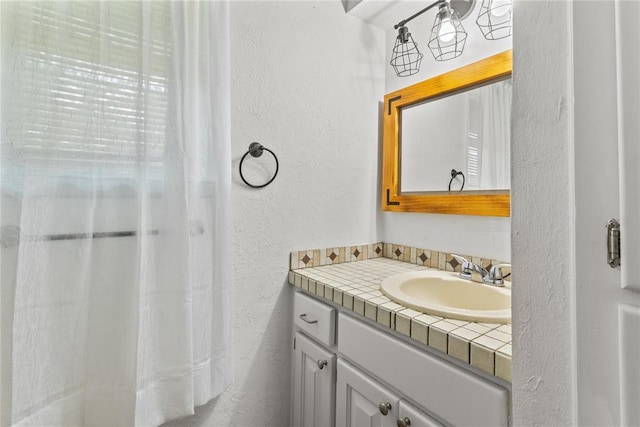 2020 Lyle Rd, Weatherford, OK 73096 - bathroom with a textured wall and vanity