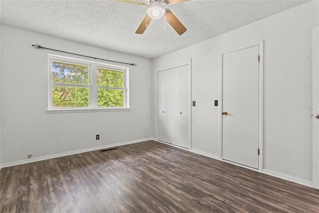 2020 Lyle Rd, Weatherford, OK 73096 - unfurnished bedroom with wood finished floors, a textured ceiling, baseboards, a ceiling fan, and a closet