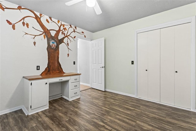 2020 Lyle Rd, Weatherford, OK 73096 - unfurnished bedroom with dark wood-style floors, baseboards, a closet, and ceiling fan