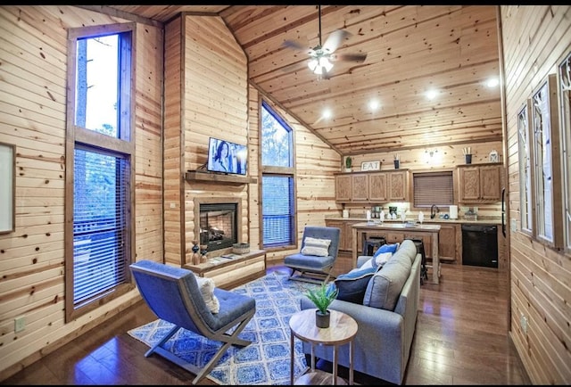 56 Muscadine Trl, Broken Bow, OK 74728 - living area featuring wood walls, wood ceiling, hardwood / wood-style floors, high vaulted ceiling, and a stone fireplace