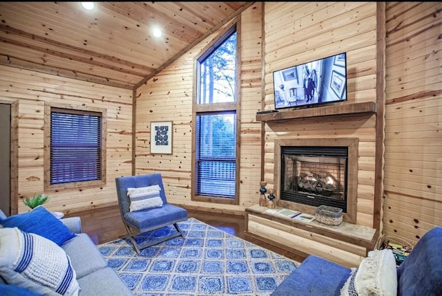 56 Muscadine Trl, Broken Bow, OK 74728 - living area with wood walls, wooden ceiling, recessed lighting, a fireplace with raised hearth, and wood finished floors
