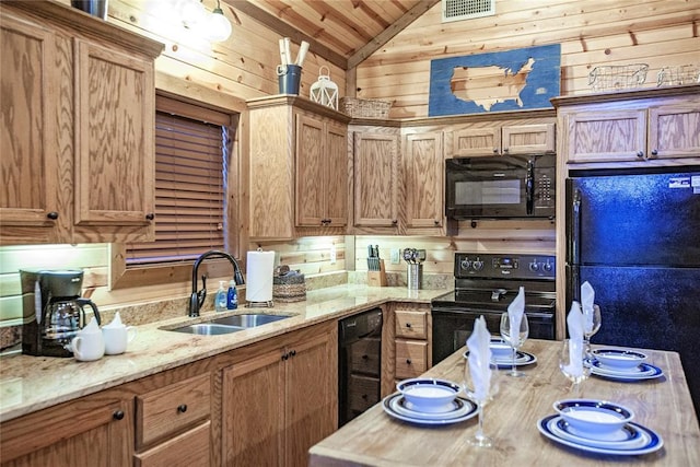 56 Muscadine Trl, Broken Bow, OK 74728 - kitchen featuring black appliances, a sink, lofted ceiling, wooden walls, and light stone countertops
