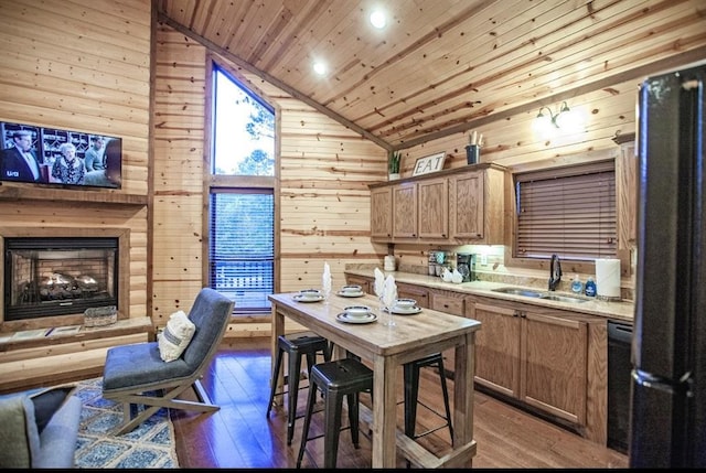 56 Muscadine Trl, Broken Bow, OK 74728 - kitchen with a sink, wood ceiling, freestanding refrigerator, wooden walls, and hardwood / wood-style floors