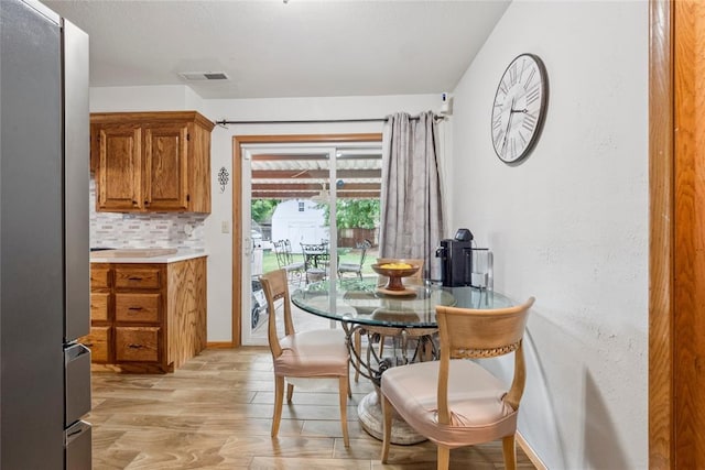 201 Vine St, Yukon, OK 73099 - dining space with light wood-style floors and baseboards