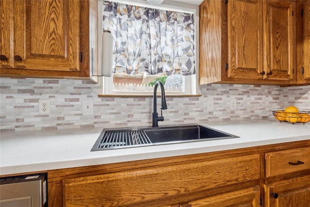 201 Vine St, Yukon, OK 73099 - kitchen with a sink, light countertops, brown cabinets, and tasteful backsplash