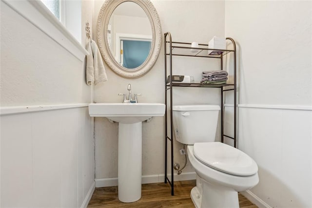 201 Vine St, Yukon, OK 73099 - half bathroom with wood finished floors, toilet, a sink, and baseboards