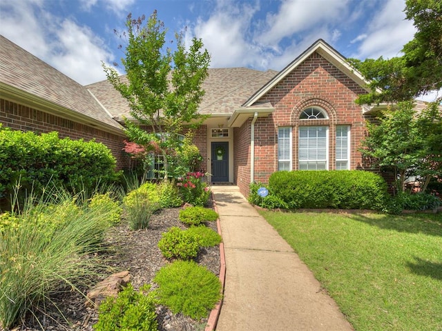 13925 Middleberry Rd, Edmond, OK 73013 - view of front of home featuring brick siding, a front lawn, and a shingled roof