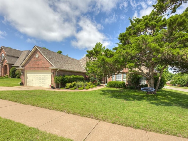 13925 Middleberry Rd, Edmond, OK 73013 - view of front of home featuring brick siding, an attached garage, a front yard, concrete driveway, and roof with shingles