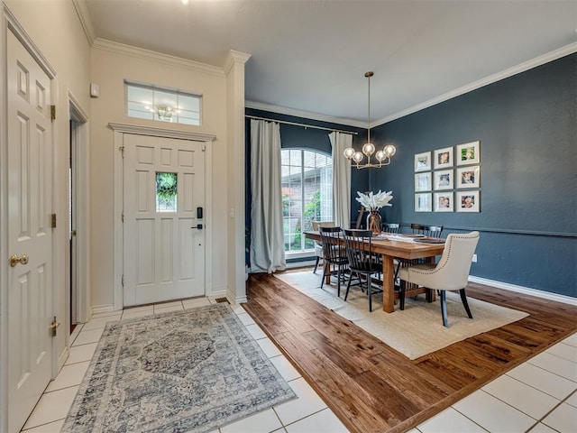 13925 Middleberry Rd, Edmond, OK 73013 - entryway featuring a chandelier, light tile patterned floors, crown molding, and baseboards