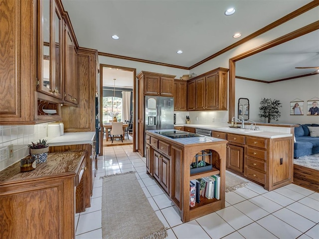 13925 Middleberry Rd, Edmond, OK 73013 - kitchen featuring crown molding, backsplash, light tile patterned floors, brown cabinetry, and a peninsula