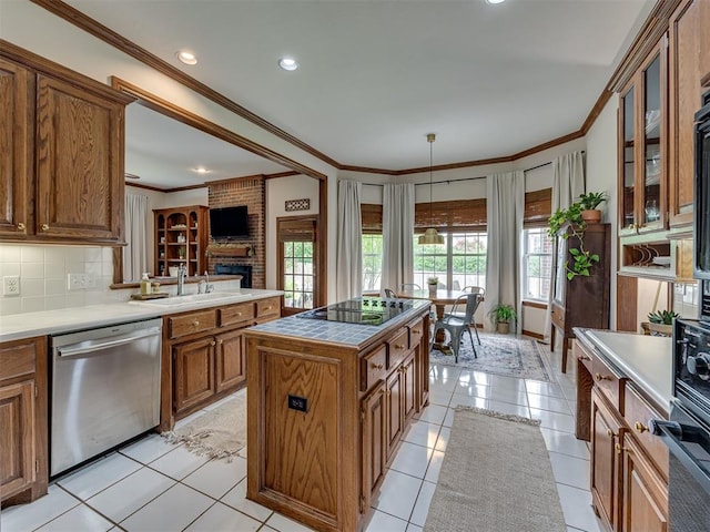 13925 Middleberry Rd, Edmond, OK 73013 - kitchen with black appliances, brown cabinets, ornamental molding, a sink, and a fireplace