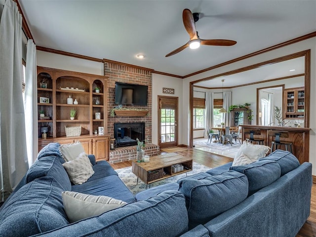 13925 Middleberry Rd, Edmond, OK 73013 - living room with ornamental molding, wood finished floors, ceiling fan, a fireplace, and recessed lighting