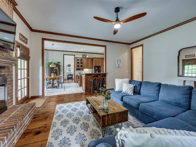 13925 Middleberry Rd, Edmond, OK 73013 - living area with light wood-type flooring, a ceiling fan, ornamental molding, and baseboards