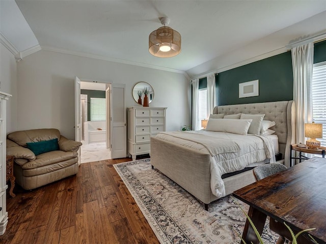 13925 Middleberry Rd, Edmond, OK 73013 - bedroom with dark wood finished floors, ornamental molding, vaulted ceiling, and ensuite bath