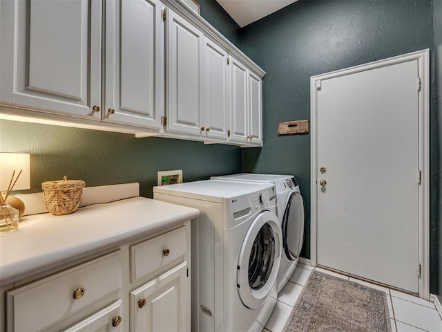 13925 Middleberry Rd, Edmond, OK 73013 - laundry room featuring cabinet space, light tile patterned flooring, separate washer and dryer, and a textured wall