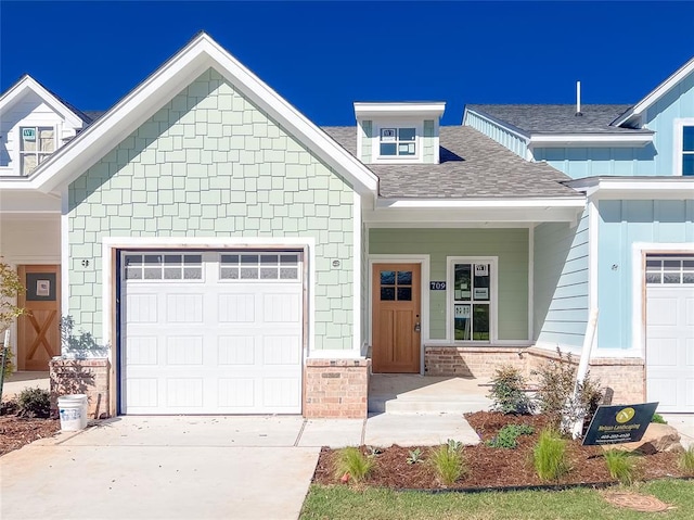 709 Montauk Way, Edmond, OK 73034 - craftsman house with a garage, driveway, and roof with shingles