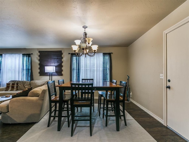 1545 N Pennsylvania Ave, Shawnee, OK 74804 - dining room featuring a chandelier, wood finished floors, and baseboards
