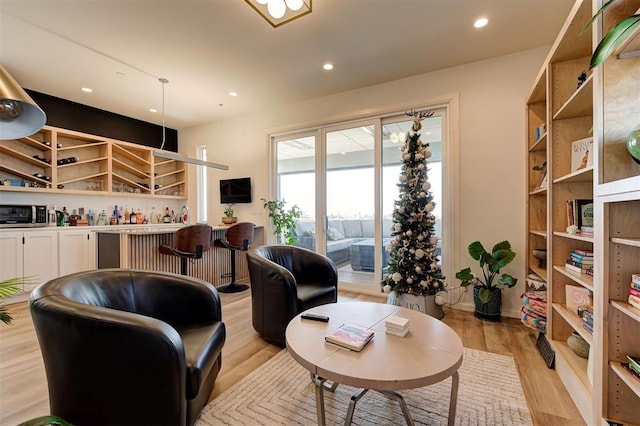 571 S Fretz Ave, Edmond, OK 73003 - living room featuring light wood-style flooring, recessed lighting, and a bar
