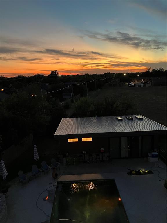 571 S Fretz Ave, Edmond, OK 73003 - pool at dusk with an outdoor pool and a patio