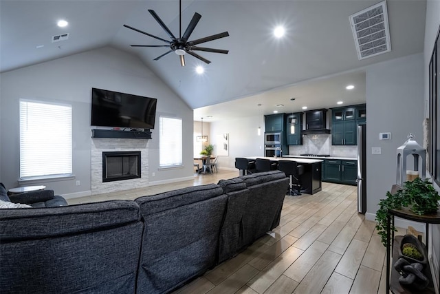 8725 NW Kensington Pl, Lawton, OK 73505 - living area with a ceiling fan, a fireplace, vaulted ceiling, light wood-style flooring, and recessed lighting