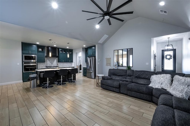 8725 NW Kensington Pl, Lawton, OK 73505 - living room featuring ceiling fan, light wood-style flooring, high vaulted ceiling, recessed lighting, and plenty of natural light
