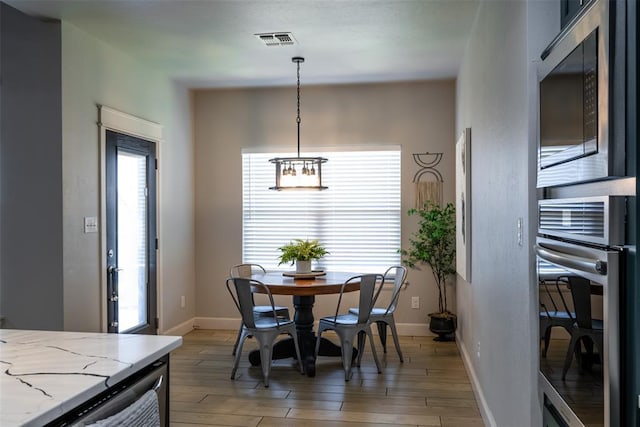 8725 NW Kensington Pl, Lawton, OK 73505 - dining room with light wood-style flooring and baseboards