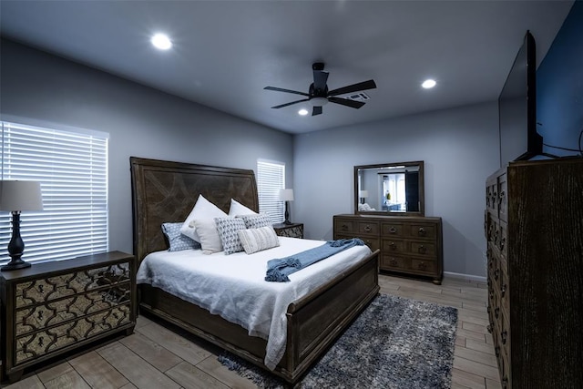 8725 NW Kensington Pl, Lawton, OK 73505 - bedroom with multiple windows, light wood-style flooring, a ceiling fan, and recessed lighting