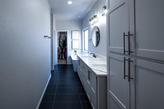 8725 NW Kensington Pl, Lawton, OK 73505 - full bathroom featuring double vanity, tile patterned floors, a spacious closet, baseboards, and recessed lighting
