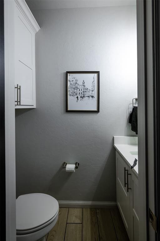 8725 NW Kensington Pl, Lawton, OK 73505 - half bath with wood finished floors, vanity, toilet, and baseboards