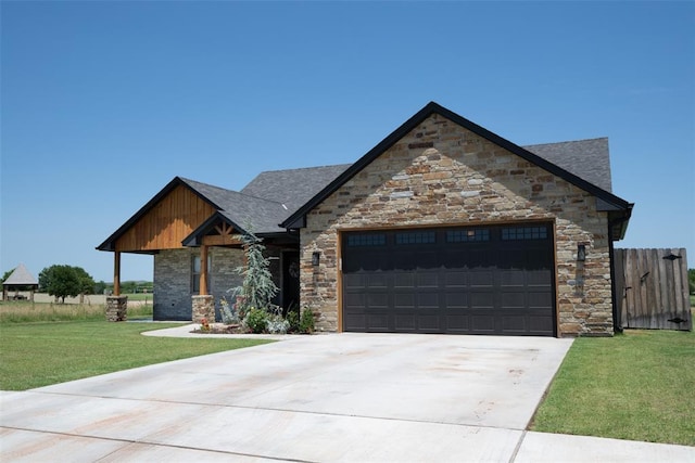 8725 NW Kensington Pl, Lawton, OK 73505 - view of front of home featuring a garage, stone siding, concrete driveway, and a shingled roof