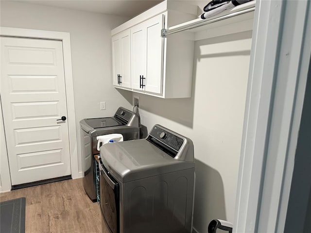2320 Dixie Dr, Blanchard, OK 73010 - laundry room featuring washing machine and clothes dryer, cabinet space, and light wood-style flooring
