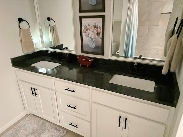 2320 Dixie Dr, Blanchard, OK 73010 - full bathroom with double vanity, a shower with shower curtain, and toilet