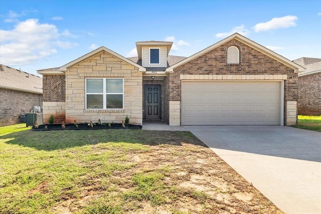 9912 Ruger Rd, Yukon, OK 73099 - view of front of home with concrete driveway, a front lawn, an attached garage, and cooling unit