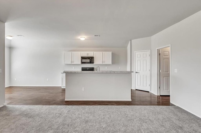 9912 Ruger Rd, Yukon, OK 73099 - kitchen featuring black microwave, dark colored carpet, white cabinets, and baseboards