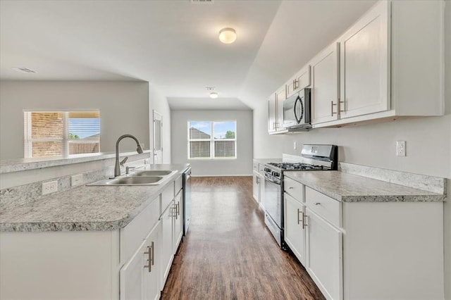 9912 Ruger Rd, Yukon, OK 73099 - kitchen with stainless steel appliances, a sink, dark wood-type flooring, white cabinets, and light countertops