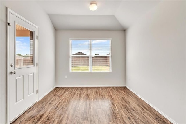 9912 Ruger Rd, Yukon, OK 73099 - unfurnished room featuring wood finished floors, plenty of natural light, baseboards, and lofted ceiling