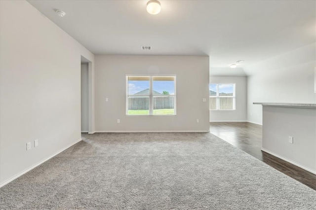 9912 Ruger Rd, Yukon, OK 73099 - unfurnished living room featuring baseboards and carpet flooring